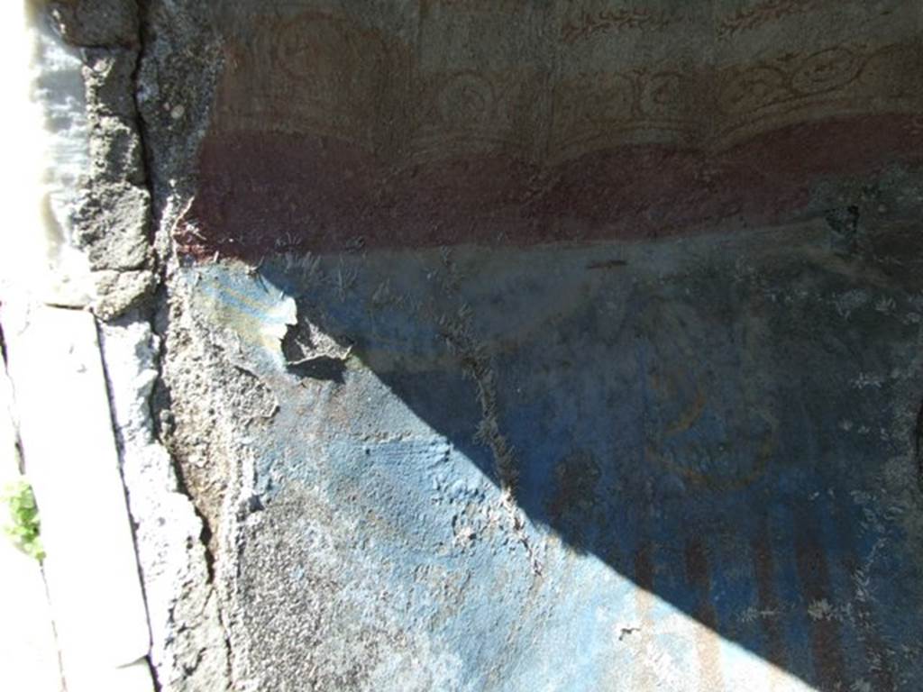 I.2.17 Pompeii. March 2009. North end of Niche on East wall. Detail of the remains of painted blue drapery.