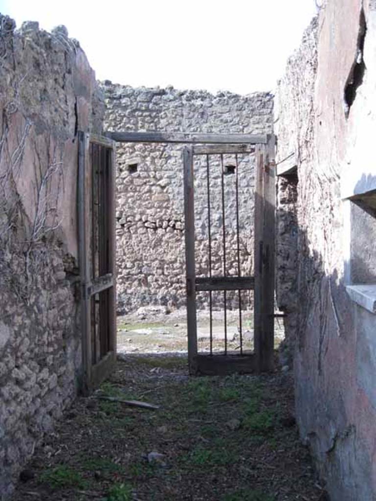 I.2.17 Pompeii. March 2009. Lararium niche of coloured marble, in east wall of fauces. According to Boyce, the walls, projecting floor and aedicula façade of this rectangular niche are all of greyish marble. In the floor were three holes for the bases of statuettes. See Boyce G. K., 1937. Corpus of the Lararia of Pompeii. Rome: MAAR 14. (p.22 no.9, pl.7,2)
