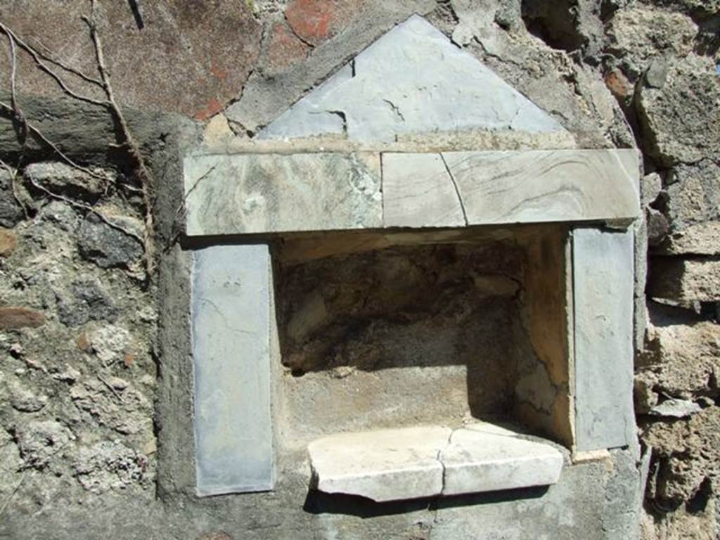 I.2.17 Pompeii. March 2009. Lararium niche of coloured marble, in east wall of fauces. According to Boyce, the walls, projecting floor and aedicula fa�ade of this rectangular niche are all of greyish marble. In the floor were three holes for the bases of statuettes. See Boyce G. K., 1937. Corpus of the Lararia of Pompeii. Rome: MAAR 14.  (p.22 no.9, pl.7,2)
