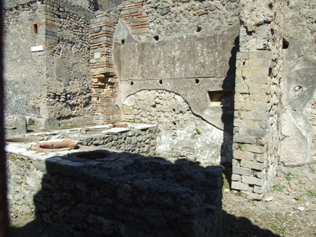 I.2.18 Pompeii. March 2009. Counter with urns and hearth, taken from doorway into I.2.17.