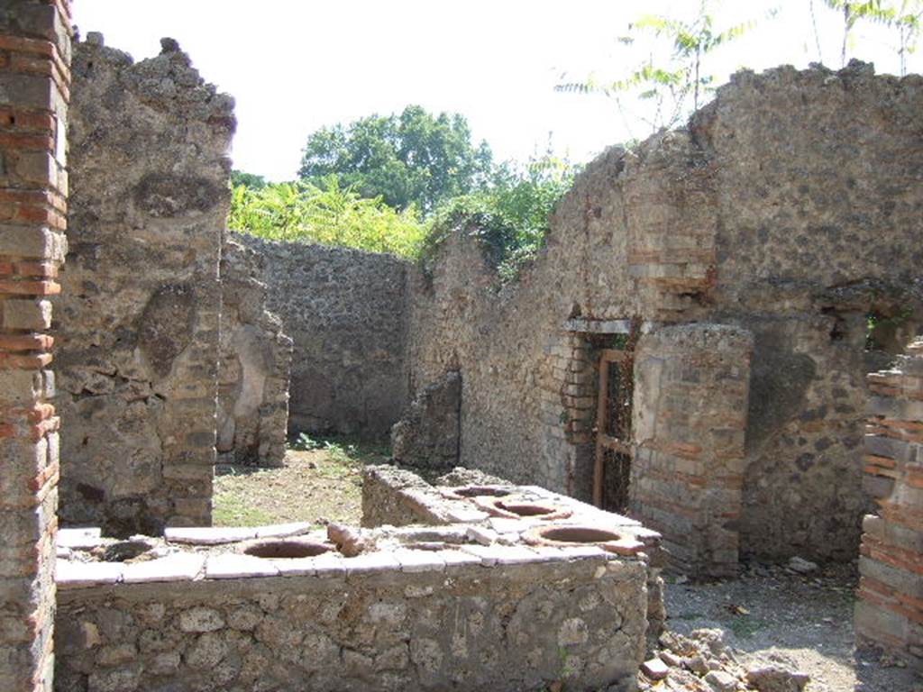 I.2.18 Pompeii. September 2005. Looking south to rear rooms, and door to I.2.17.