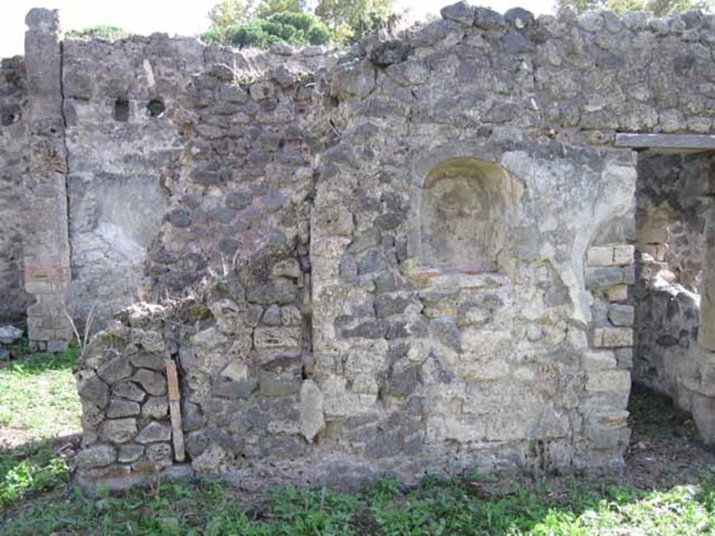 I.2.24 Pompeii. September 2010. East half of south wall of atrium, with niche. The stairs are behind the wall on the left. Photo courtesy of Drew Baker.