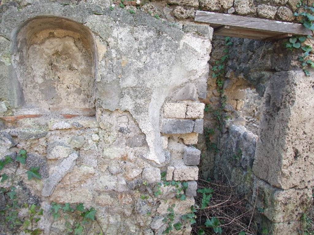 I.2.24 Pompeii. December 2006. South wall of Atrium, with Niche for the Penates. Originally one would have seen a painting of the usual serpents, two Lares, and the Genius sacrificing. At the sides of the niche were two quadrupeds, one of which was perhaps a wolf. Today only the niche remains. See Pappalardo, U., 2001. La Descrizione di Pompei per Giuseppe Fiorelli (1875). Napoli: Massa Editore. p.37