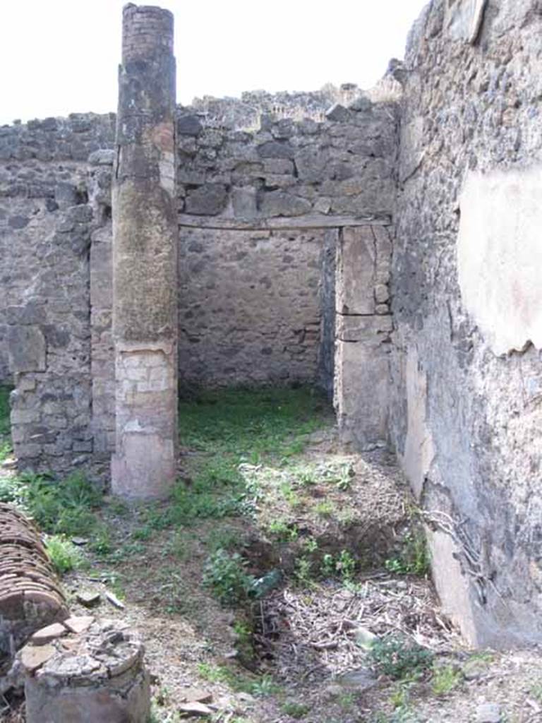 I.2.24 Pompeii. September 2010. Doorway to room in north-west corner of atrium, looking west across atrium, and site of impluvium. Photo courtesy of Drew Baker.
According to Warscher, quoting Mau in Bull. Inst, 1874, (p.252), she described –
“L’atrio è d’una forma affatto singolare.  L’impluvio, cioè, più profondo del solito, non sta nel mezzo, ma presso alla parete di N, poco lontano dall’estremità occidentale di essa, dimodochè il tetto dell’atrio veniva sorretto non da quattro ma soltante da due colonne, sulle quali riposavano le travi, una che congiungeva le due colonne, due con un’estremità incastrata nel muro di N. Conforme a ciò quella parte del muro di N, che sta sopra l’impluvio, ed era esposta alla pioggia, non partecipa della decorazione del resto, ma è rozzamente dipinta color di carne.  Dall’impluvio l’acqua scolava verso SE nel pozzo”.
See Warscher T., 1935. Codex Topographicus Pompeianus: Regio I.2. Rome: DAIR, whose copyright it remains.
(translation: “The atrium was of an unusual form. The impluvium deeper than usual was not in the middle, but near to the north wall, not far from the extreme west of this, the atrium roof was supported not by four columns but only by two columns on which rested the beams, one which linked the two columns, two with an end buried in the north wall. That part of the north wall that was above the impluvium, which was exposed to the rain, did not participate in the same decoration as the rest, but it was crudely painted flesh-coloured.  From the impluvium the water drained towards the south-east in the well.”)
