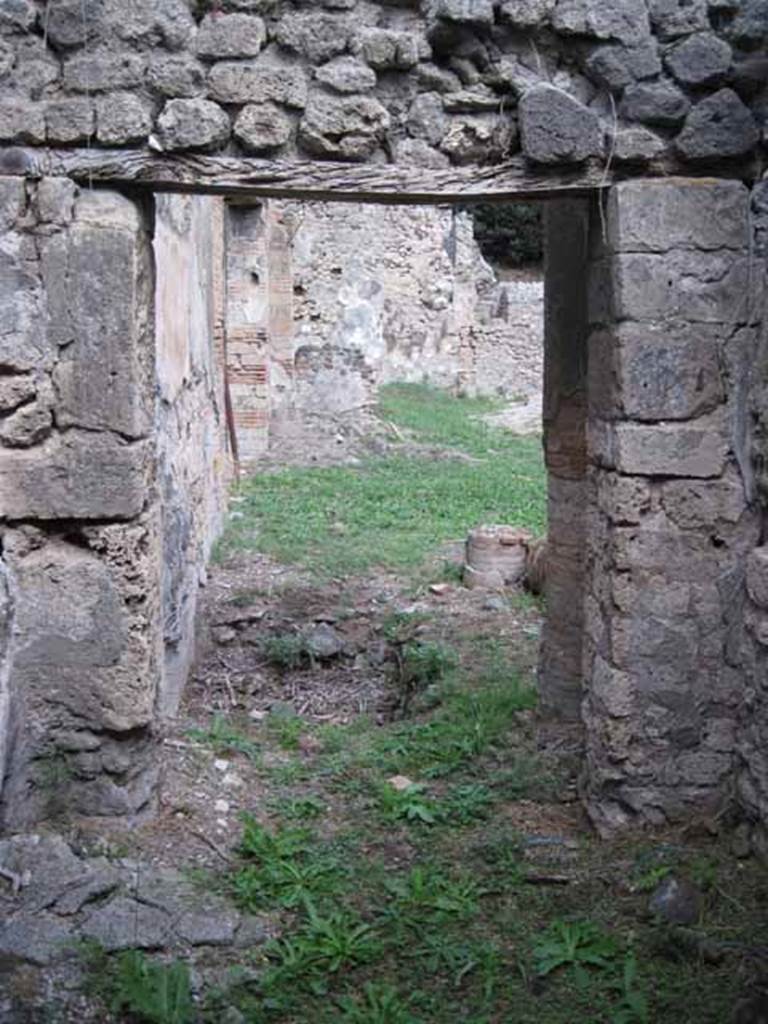 I.2.24 Pompeii. September 2010. Looking east into atrium and across impluvium, through doorway from room in north-west corner of atrium.
Photo courtesy of Drew Baker.

