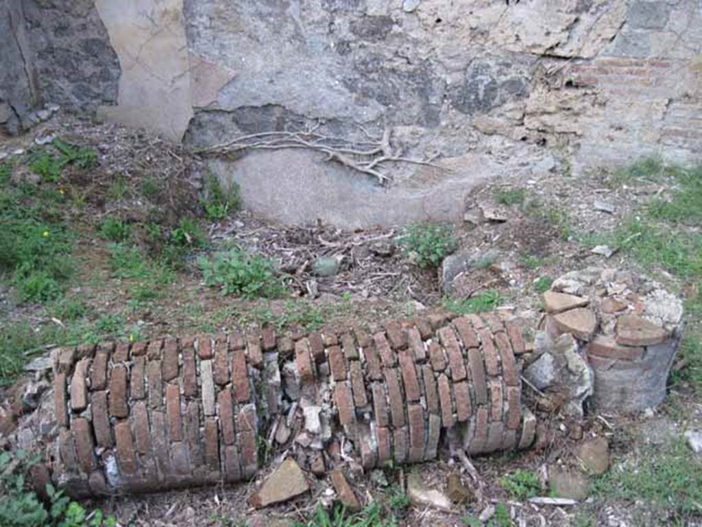 I.2.24 Pompeii. September 2010. Detail of fallen brick column and impluvium or pool in atrium looking north. Photo courtesy of Drew Baker.

