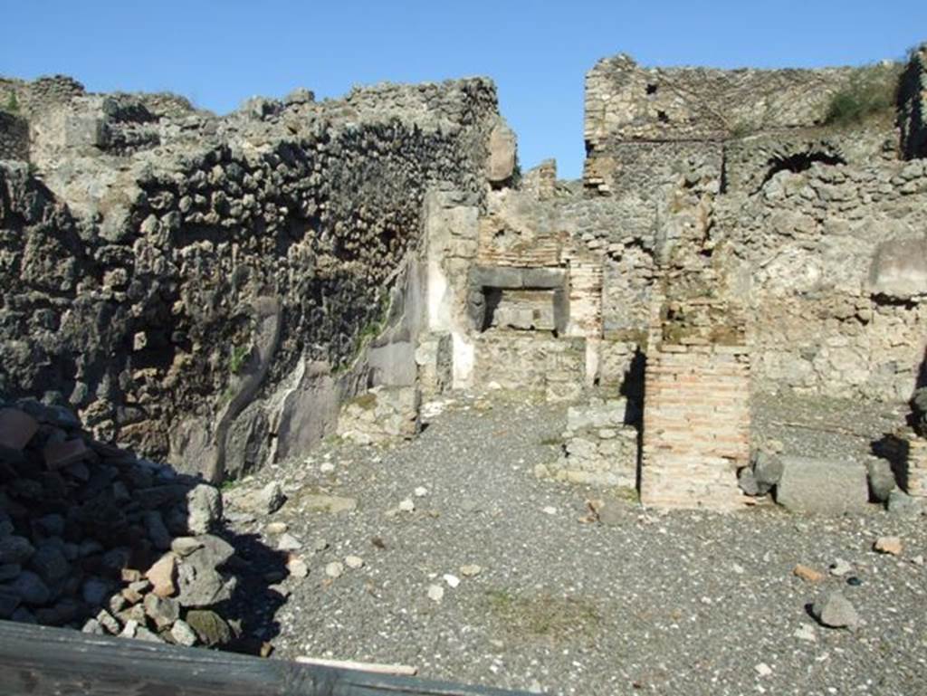 I.3.1 Pompeii. September 2010. West wall and doorway of small room, looking towards entrance from Via Stabiana, and west wall of bakery room. Photo courtesy of Drew Baker.