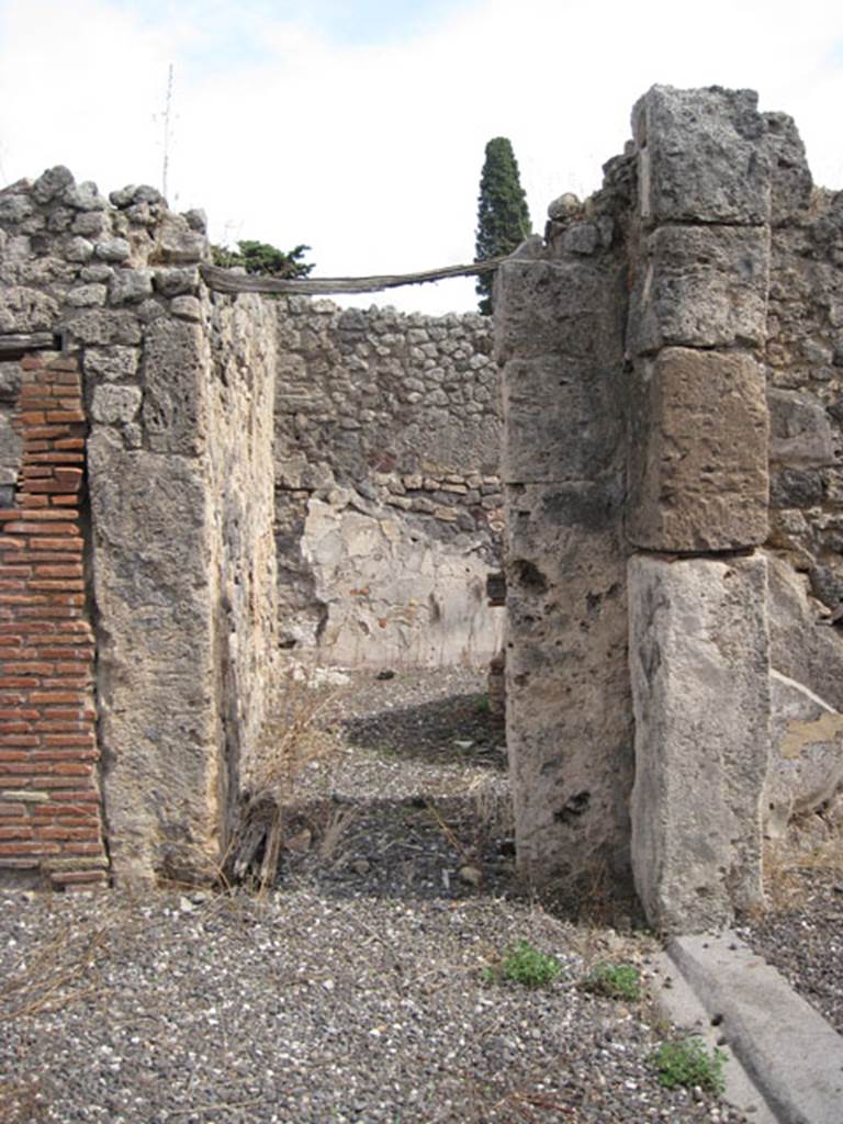 I.3.8b Pompeii. September 2010. Looking east towards doorway in south-east corner of peristyle, into a small ruined vestibule, which would have had two doorways leading from it.
One leading perhaps to a cubiculum on the east side with window into corridor/kitchen.
The other leading to a room on the south side. Photo courtesy of Drew Baker.