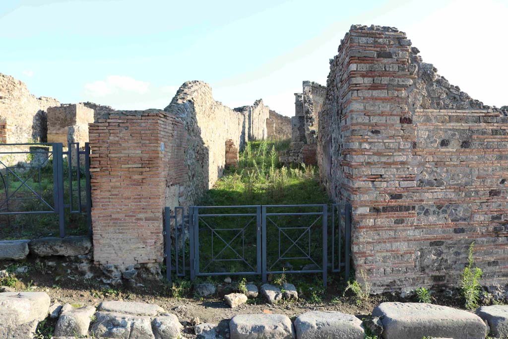 I.3.8 Pompeii. December 2018. Looking east from across via Stabiana towards entrance to angiportus or alleyway.
This angiportus provides access to two distinctly separate houses.
I.3.8a with entrance on right of main corridor. I.3.8b House of Vulcanus with entrance straight ahead. Photo courtesy of Aude Durand.