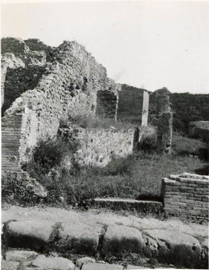 I.3.10 Pompeii. 1935 photograph taken by Tatiana Warscher, looking east towards entrance from Via Stabiana. 
See Warscher, T, 1935: Codex Topographicus Pompejanus, Regio I, 3: (no.26), Rome, DAIR, whose copyright it remains.  
According to Warcher, �This was a workshop with other rooms, altered from the ancient configuration by the route of the Sarno canal built by Fontana: here one can see the remains of wash-tubs and furnaces that existed here before�.
