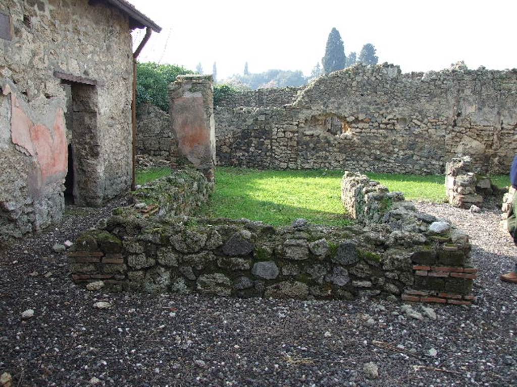I.3.25 Pompeii. December 2006. Looking west across 3-sided pseudoperistyle to garden area. According to Schefold, on the south-west corner pillar there was a painting of a flying Isis Fortuna with a horn of plenty and a globe. See Schefold, K., 1957. Die W�nde Pompejis. Berlin: De Gruyter. (p. 13).
According to Trendelenburg, this small rectangular peristyle was open to the west side onto a small garden area. The other three sides were surrounded by a low podium of material, on which rested four brick columns, originally faced with coloured stucco. The peristyle was being restored at the time of the catastrophe in 79AD. The podium on the left side ended with a large pilaster. This surviving pilaster, on a background of red stucco, showed a different type of female flying figure (height I.15m). She was naked, except for a transparent yellow mantle, covering her from her breast to her knees. In her right hand she held a wreath or crown of laurel, in her left was a cornucopia. At her feet was a globe.
See Trendelenburg in BdI 1871 (p.173) 
According to Sogliano, Nike (Victory) with a yellow transparent veil painted on a red background, was found on the corner pilaster in the south-west corner of the peristyle.
See Sogliano, A., 1879. Le pitture murali campane scoverte negli anni 1867-79. Napoli: Giannini. (p.72, no.431) 
