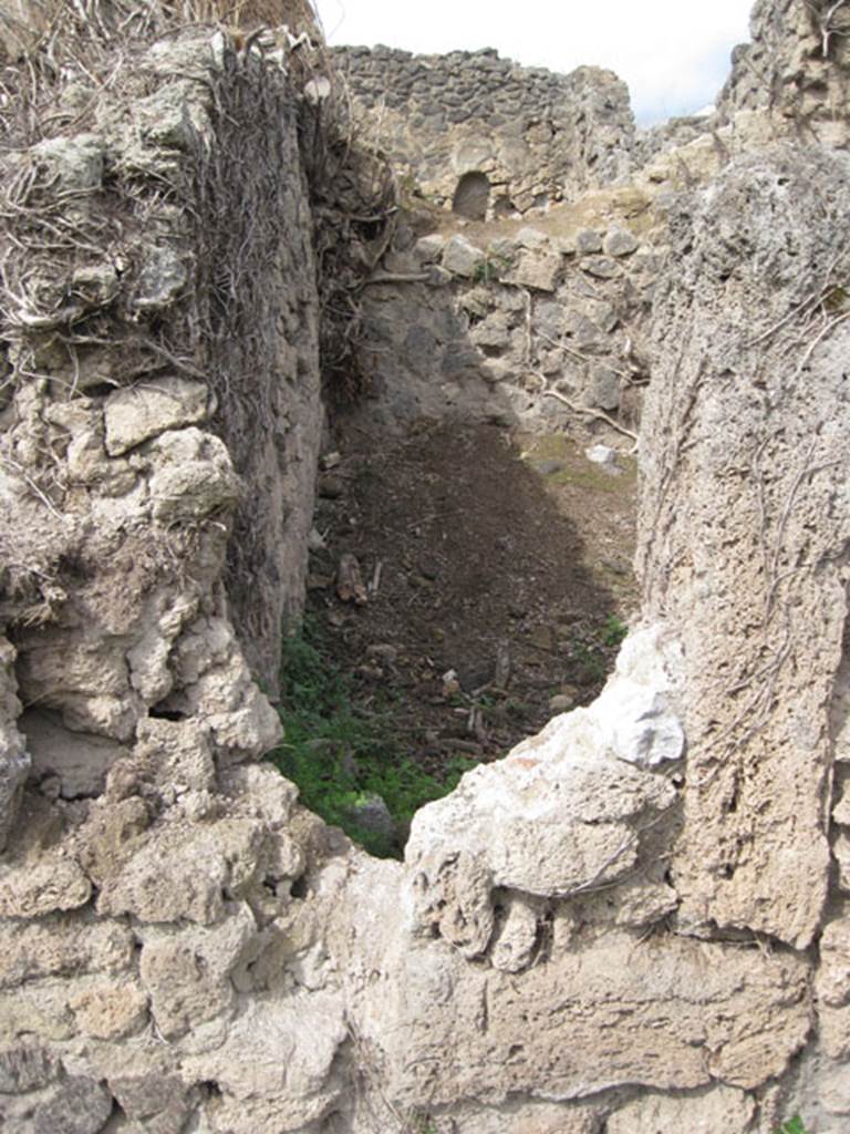 I.3.27 Pompeii. September 2010. Looking north from I.3.3 towards reverse of south-west corner of the above room.  Drew Baker says � the photo was taken to compare form of the aperture. 
The eastern side appears to have a tufa framing member and the base at least a partial threshold however there is no corresponding part on the western side which I would expect. However there is a wall there so it may not have been necessary but as there is what appears to be original fill either this is a door which was blocked up at some point or it is a feature of construction (opus africanum perhaps). 
Photo courtesy of Drew Baker.
