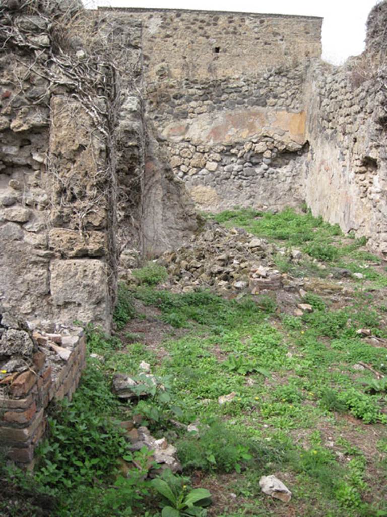 I.3.30 Pompeii. September 2010. Looking north from entrance corridor towards peristyle area. Photo courtesy of Drew Baker.
According to Jashemski, �the peristyle garden of this small house without an atrium (excavated 1872) was to the right of the north end of the entrance passageway. The garden was enclosed on the west, north, and on part of the south sides by a portico supported by columns joined by a low wall�.  See Jashemski, W. F., 1993. The Gardens of Pompeii, Volume II: Appendices. New York: Caratzas. (p.28)
