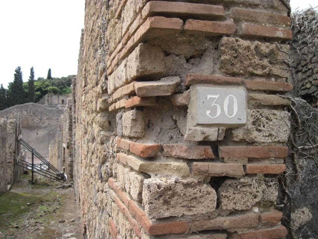 I.3.30 Pompeii. September 2010. ID number plate on west side of entrance doorway.
Photo courtesy of Drew Baker. Looking west along unnamed vicolo towards Via Stabiana. Fiorelli called this vicolo “via secunda”. See Pappalardo, U., 2001. La Descrizione di Pompei per Giuseppe Fiorelli (1875). Napoli: Massa Editore. (p.41)