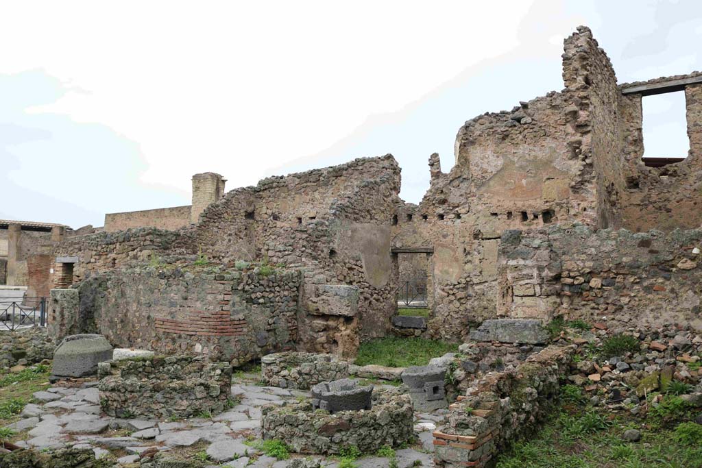 I.4.12 Pompeii. December 2018. Looking north-west across bakery rooms towards doorway at I.4.17 on Via dell�Abbondanza.
Photo courtesy of Aude Durand.
