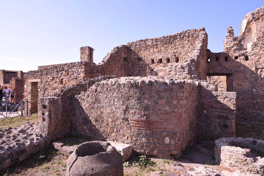 I.4.12 Pompeii. October 2019. 
Room b, bakery room, north-west corner, with rear of oven in I.4.13, in centre, and doorway into room h, on right.
Foto Tobias Busen, ERC Grant 681269 D�COR.
