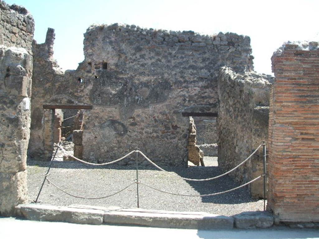 I.4.17 Pompeii. May 2005. Entrance on Via dell’Abbondanza. Looking south.
Two large terracotta dolia were found buried in the soil of the shop-room. They contained “farina molita” (flour) that Fiorelli thought was probably sold from there. They are no longer visible.
See Pappalardo, U., 2001. La Descrizione di Pompei per Giuseppe Fiorelli (1875). Napoli: Massa Editore. (p.43).

According to Della Corte, on the pilaster to the right of the shop, CIL IV 768 was found:
M.  Epidium  Sabinum  d(uumvirum) i(ure) dic(undo) o(ro) v(os) f(aciatis) dignus  est defensorem  coloniae  ex  sententia  Suedi  Clementis  sancti  Iudicis consensu  ordinis,  ob  merita  eius  et  probitatem  dignum  rei publicae  faciat(is)  Sabinus  dissignator  cum  Plausu  facit.  
See Della Corte, M., 1965.  Case ed Abitanti di Pompei. Napoli: Fausto Fiorentino. (p. 244, 
together with Note 1 – which says “For the precise topography of this programme, see PAH II, p.571)

