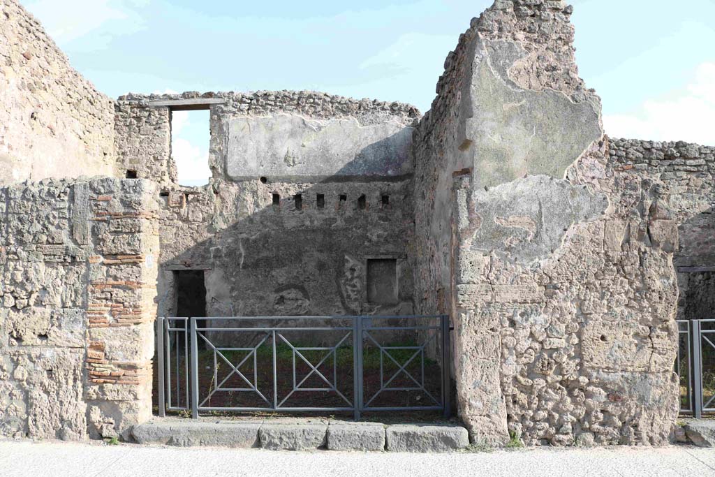 I.4.18 Pompeii. September 2018. Looking south on Via dell�Abbondanza towards entrance. Photo courtesy of Aude Durand.
Della Corte thought this would be the shop and dwelling of the Sabinus that had acclaimed his neighbour M. Epidio Sabino, on the right pilaster of I.4.17:
Sabinus dissignator cum plausu facit (part of CIL IV 768, see I.4.17).
See Della Corte, M., 1965.  Case ed Abitanti di Pompei. Napoli: Fausto Fiorentino, p. 255.
