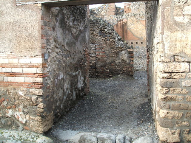 I.4.28 Pompeii.  Domus of Q. Octavius Romulus.  Room 5.  Stables with drinking trough.  East wall with windows on two floors.