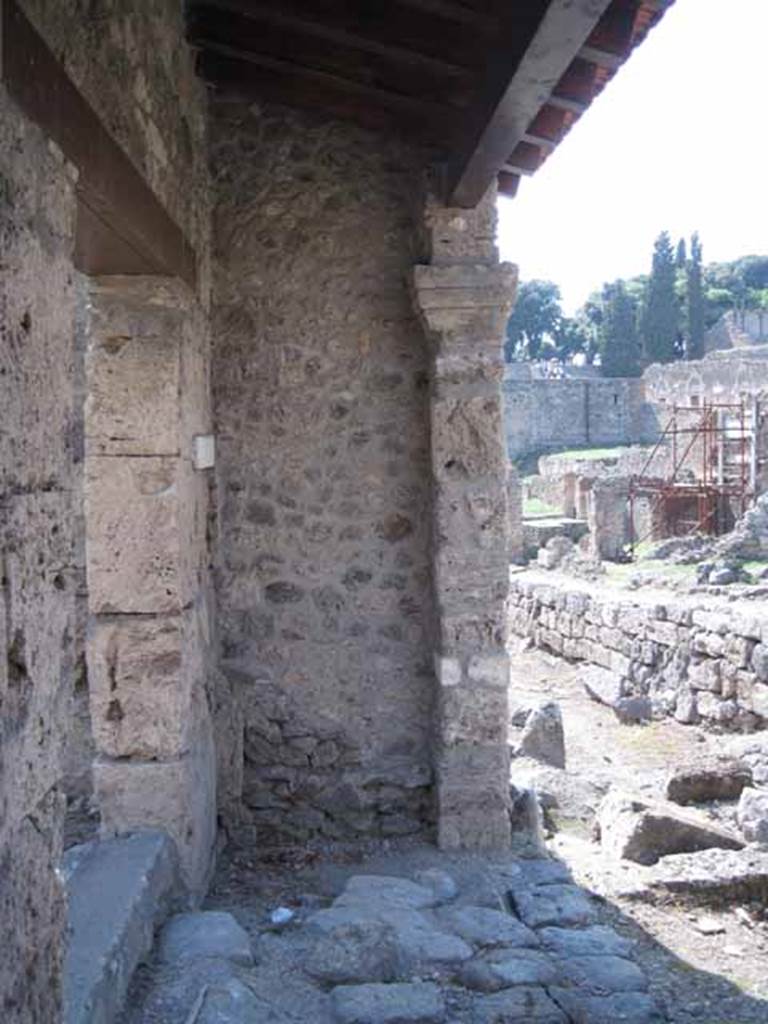 I.5.1 Pompeii. September 2010. Right (west) ante of restored portico looking west along Vicolo del Conciapelle towards Via Stabiana (entrance left of image). Photo courtesy of Drew Baker.