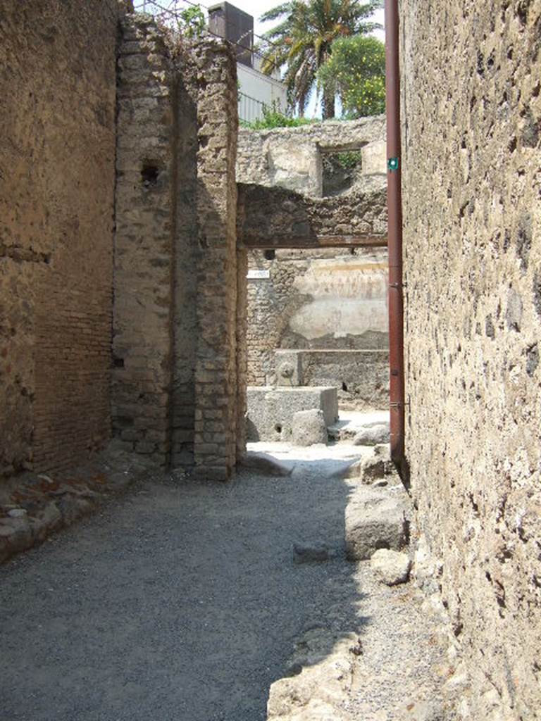 I.6.1. May 2006.   Vicolo di Paquius Proculus.            I.7.
Looking north past remains of water column to Shrine of 12 Gods.   
