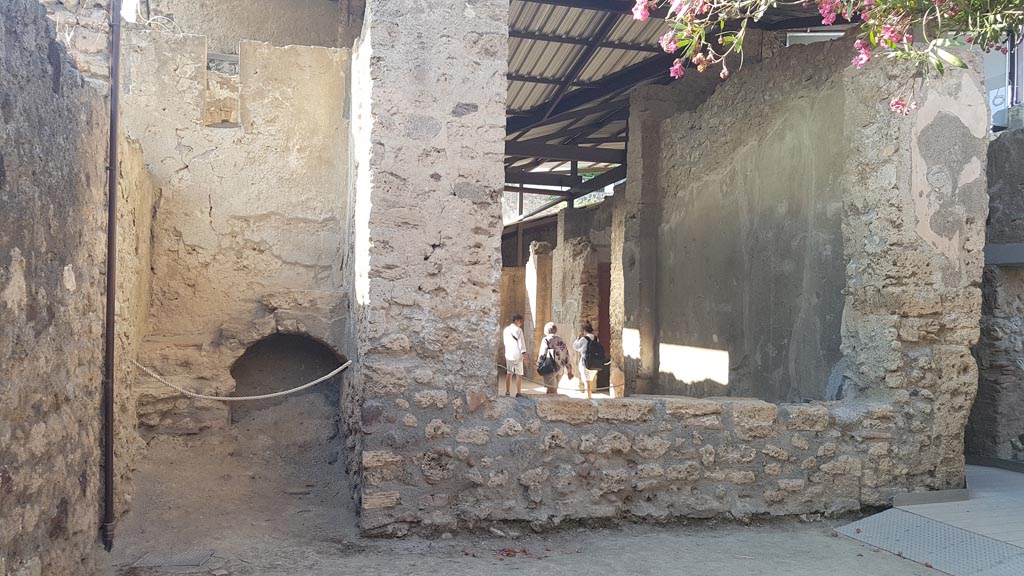 I.6.4 Pompeii. August 2023.
Looking north towards room 14, stairs to upper floor, on left, and window into tablinum, on right. Photo courtesy of Maribel Velasco.