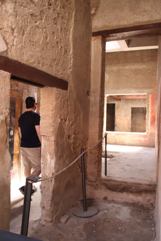 I.7.3 Pompeii. September 2019. Looking south from entrance I.7.2.
On the left is the doorway connecting to the entrance corridor of I.7.3.
On the right, looking south through site of staircase, through a room that would have been under the stairs, into atrium of I.7.3.