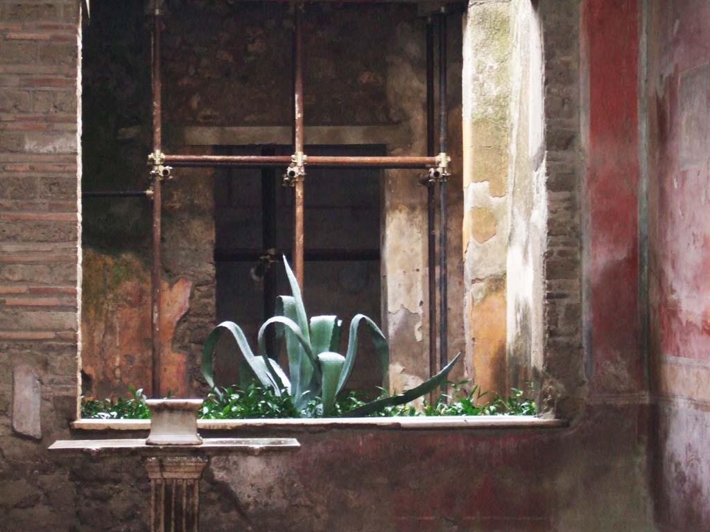 I.7.3 Pompeii. December 2005. Looking south across atrium through window to small garden, in area normally occupied by a tablinum.
The doorway to a cubiculum can be seen at the rear.