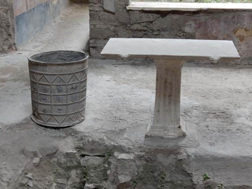 I.7.3 Pompeii. May 2017. Looking towards south side of impluvium, with lead bucket and table. Photo courtesy of Buzz Ferebee.