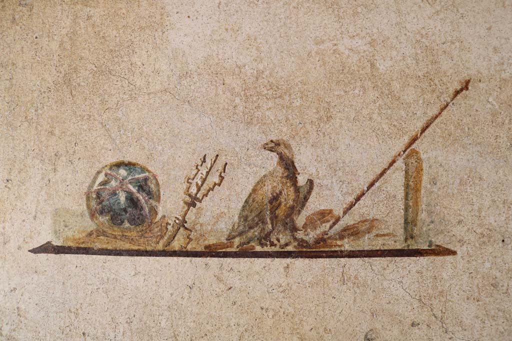 I.7.11 Pompeii. December 2018.
Wall painting of the attributes of Jupiter, from centre panel of east wall in cubiculum. Photo courtesy of Aude Durand.