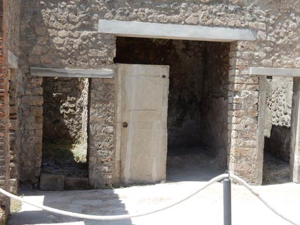 I.7.19 Pompeii. May 2017. Doorways to rooms in north-west corner of atrium. Photo courtesy of Buzz Ferebee.
In the centre is a plaster-cast of a door.