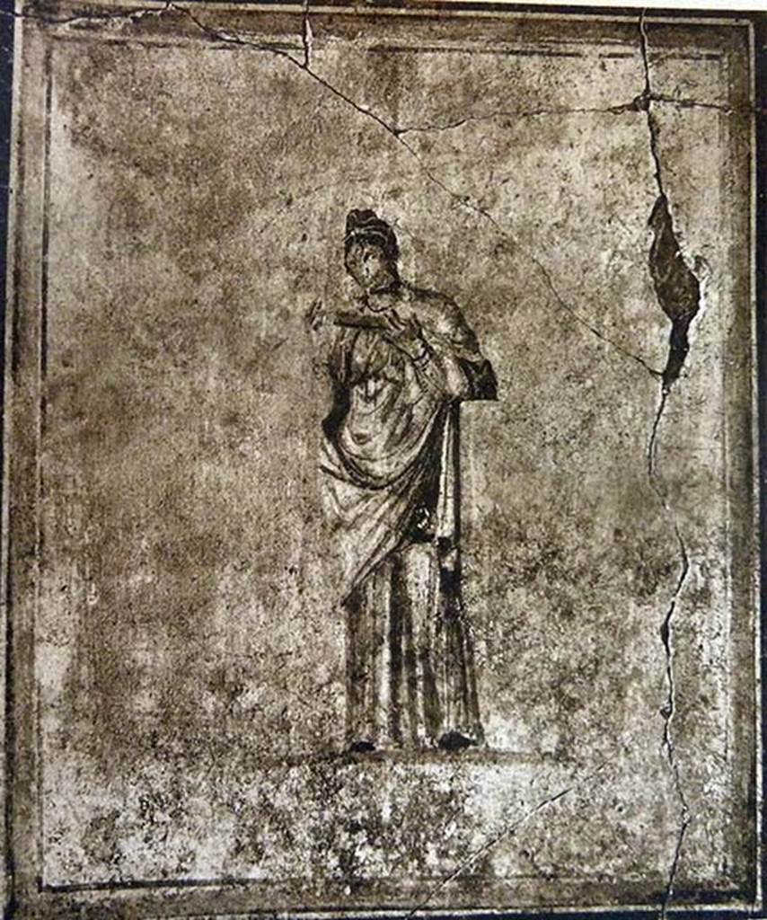 I.7.14 Pompeii. Old undated photograph showing female figure in a long robe.
She held in her raised hands an object possibly a scroll.
She was identified as possibly the Muse, Calliope.
The painting was part of the decoration, on a white background, of the upper north wall of the cenacolo of the upper floor.
