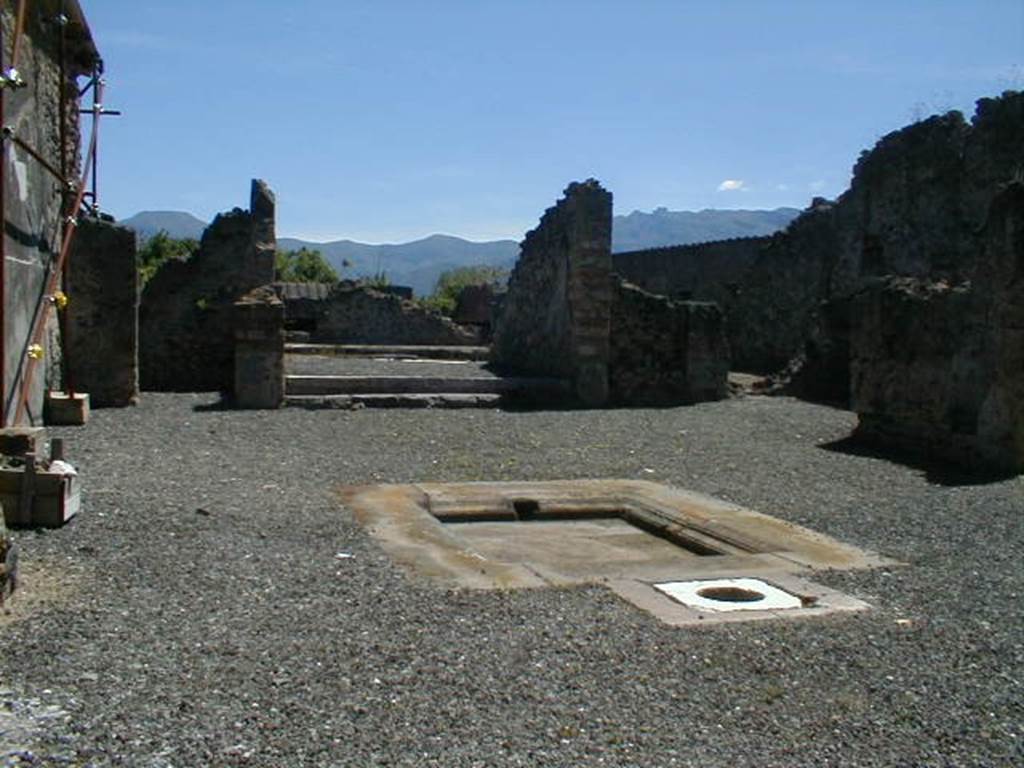 I.8.2 Pompeii. May 2004. Looking south across atrium to tablinum with peristyle beyond. According to Jashemski, two steps led up to the tablinum from the atrium. At the rear of the tablinum was the peristyle, which was enclosed by a portico on four sides. None of the columns are standing today, and part of the floor on the north, east and west portico was also destroyed by bombing in 1943. A gutter at the edge of the garden collected rain water which was stored in the large cistern under the peristyle. The water appeared to have been used in the adjacent dye-shop (I.8.19) at the rear. See Jashemski, W. F., 1993. The Gardens of Pompeii, Volume II: Appendices. New York: Caratzas. (p.42)