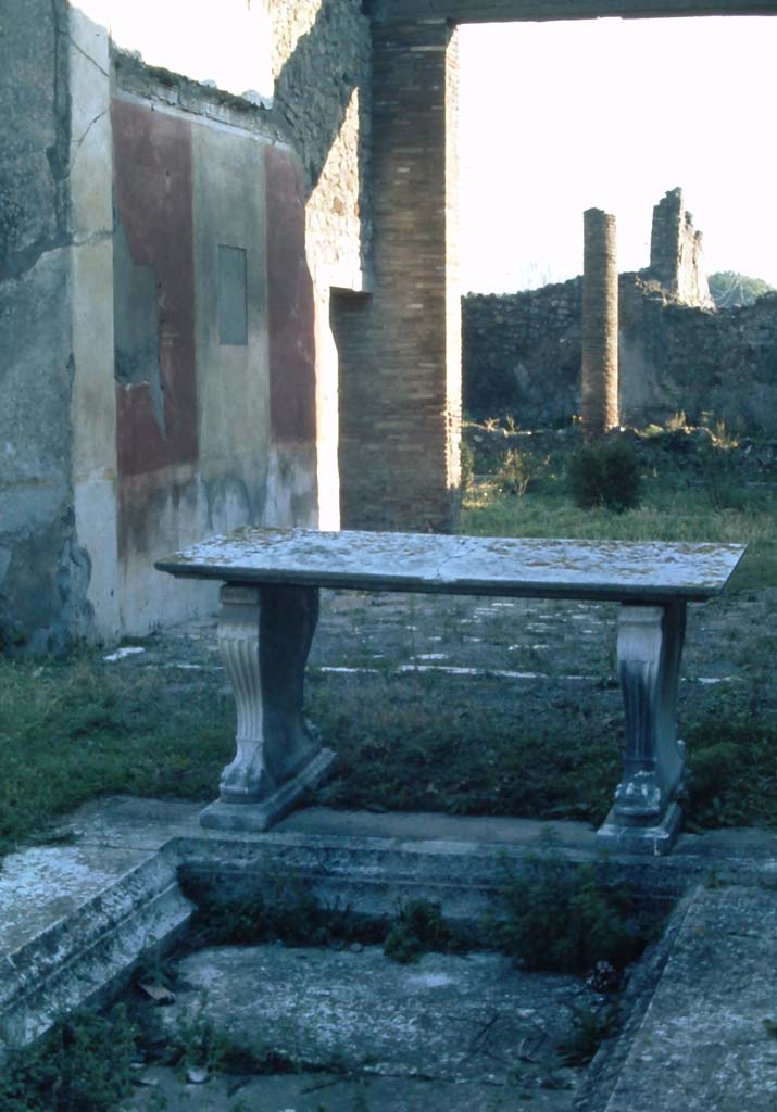 1.8.5 Pompeii. 4th December 1971. Looking across impluvium in atrium, towards east wall of tablinum.
Photo courtesy of Rick Bauer, from Dr.George Fay’s slides collection.