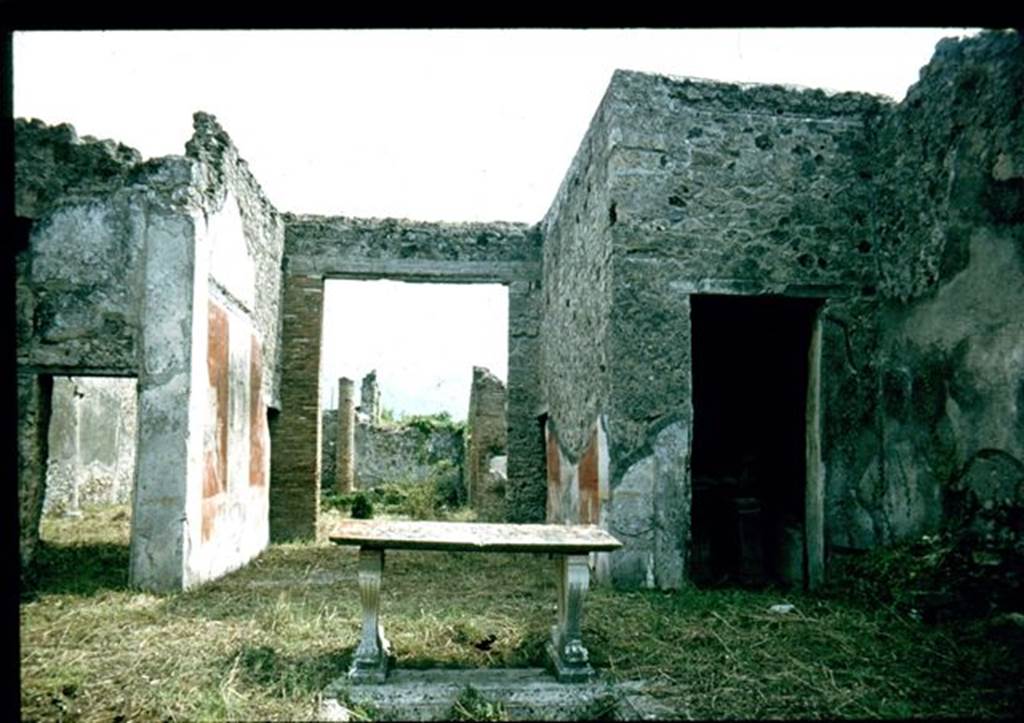 I.8.5 Pompeii. Looking south from impluvium towards tablinum and garden.
In the room with the doorway on the right, (south-west corner of atrium) a ship graffiti was seen on the white west wall of the cubiculum. At the rear of the garden was the triclinium. Photographed 1970-79 by Günther Einhorn, picture courtesy of his son Ralf Einhorn.