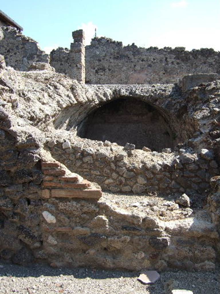 I.8.19 Pompeii. September 2005. Cistern at lower level, with peristyle of I.8.2 above. According to Jashemski, part of the floor on the north, east and west portico of the peristyle of I.8.2, was destroyed by bombing in 1943. A gutter at the edge of the garden collected rain water which was stored in the large cistern under the peristyle. The water appeared to have been used in the adjacent dye-shop (I.8.19) at the rear. See Jashemski, W. F., 1993. The Gardens of Pompeii, Volume II: Appendices. New York: Caratzas. (p.42)