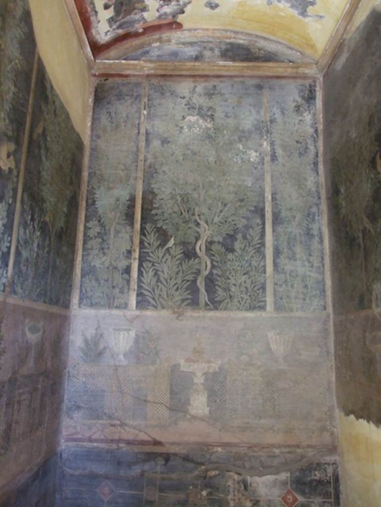 I.9.5 Pompeii. March 2009. Room 11.Cubiculum. East wall. Garden painting with serpent in a fig tree, lattice fencing, white vases and table with Isis cup or jar