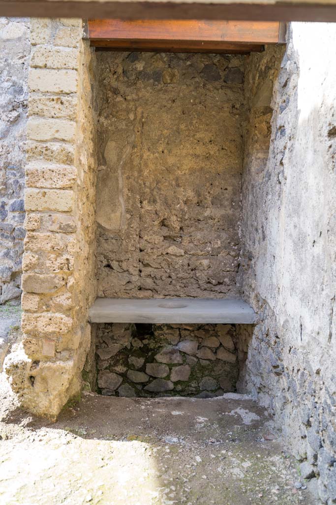 I.9.5 Pompeii. April 2022.
Room 15, looking towards latrine in kitchen area. Photo courtesy of Johannes Eber.
