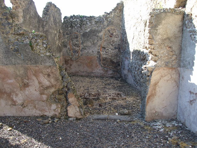 I.9.8 Pompeii. December 2006. Looking south in rear room/paved area.
On the left can be seen the windowed wall of the triclinium fenestratum, overlooking the garden area.