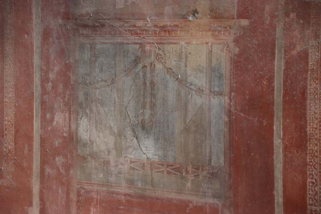 I.10.4 Pompeii. September 2021.
Room 4, detail of painted decoration from south wall below the centre painting. Photo courtesy of Klaus Heese.