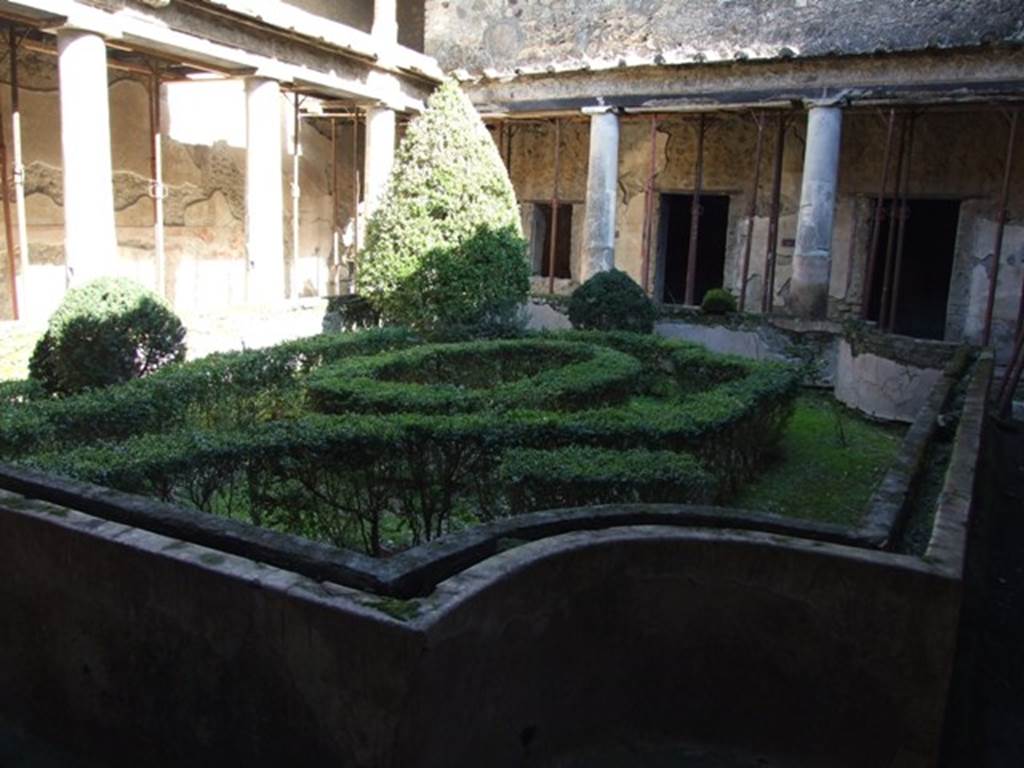 I.10.11 Pompeii. March 2009. Room 10, looking east across peristyle garden.  The garden was enclosed by a low wall with a depression in the top for soil and plants.  See Jashemski, W. F., 1993. The Gardens of Pompeii, Volume II: Appendices. New York: Caratzas. (p.50: T59).
