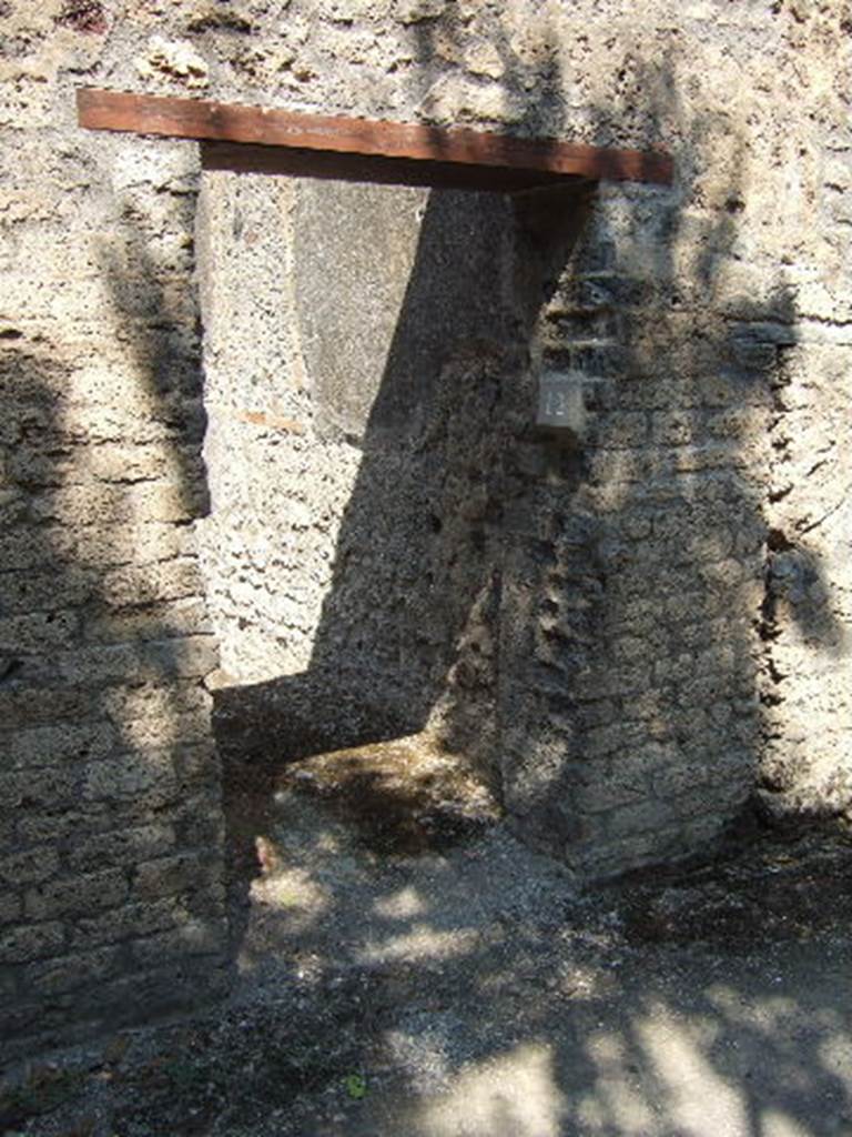 I.10.12 Pompeii. September 2005. Narrow entrance doorway.
According to NdS �
With jambs and sockets of tuff, and with a wooden threshold, access was gained to a spacious room.
This had a cocciopesto floor, walls covered with rough plaster, and a flat ceiling; the door opened to the left of the wall, to increase the lighting of the room, and a rather wide rectangular window was carved into the same south wall.
In the centre of the east wall, was a large breach from the corresponding rustic room of the Casa del Menandro and on the same wall a small doorway of communication, now closed, with the latrine of the same room.
In the west wall, the block of limestone that marked the beginning of the staircase to the upper floor was resting on the ground. 
See Notizie degli Scavi, 1934, (p.340)
