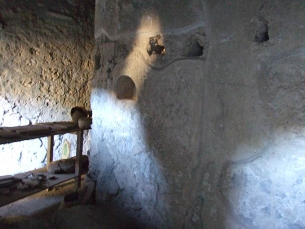 I.10.16 Pompeii. March 2009. Looking south across part of L-shaped Kitchen, the part facing west. Looking south towards wall with niche.
