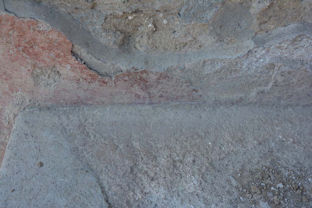 I.10.18 Pompeii. April 2017. Detail of remaining painted plaster at rear of bench seating on south side of entrance doorway.
Photo courtesy Adrian Hielscher.