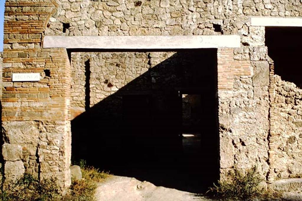 I.12 Pompeii. September 2005. Roadway, looking south. Side wall of I.11.6