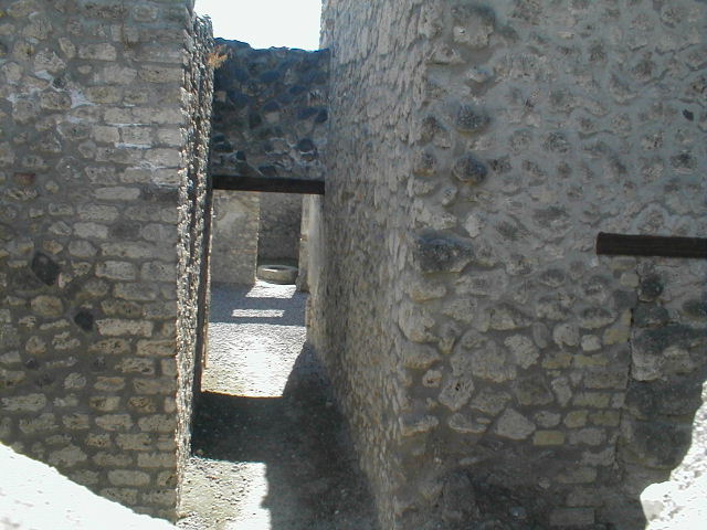 I.11.8.Kitchen with site of stairs to upper floor on left and site of latrine on right