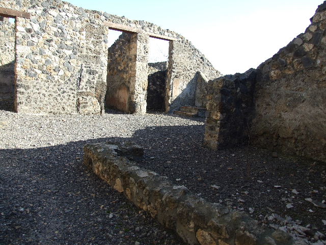 I.11.15 Pompeii. September 2005. Atrium, looking east towards doorway to room 5, corridor room 6 and room 7.

