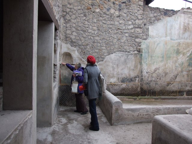 I.11.16. Casa di Saturninus.  Hospitium.  December 2007.  Room 4.  Corridor on south side of triclinium.  At the far end is a door leading to a small alcove or staircase.