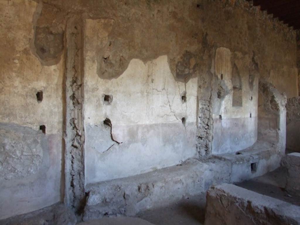 I.12.2 and I.12.1 Pompeii. March 2009 Room 13. East wall, with remains of holes for shelving supports.