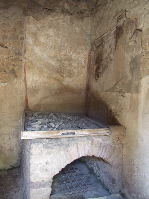 I.12.8 Pompeii. March 2009. Room 10. West wall. Remains of Lararium, painted with plants and birds. The legs of the Lares used to be visible at the top of the wall, but only their booted legs, the upper parts were destroyed.
See Giacobello, F., 2008. Larari Pompeiani: Iconografia e culto dei Lari in ambito domestico. Milano: LED Edizioni. (p.152-3).
